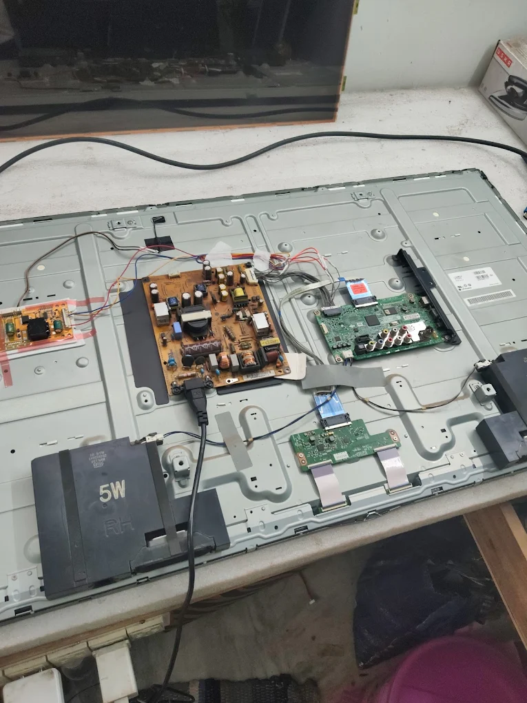 Nice Vision TV repair technician working on LED TV at home in Bhubaneswar