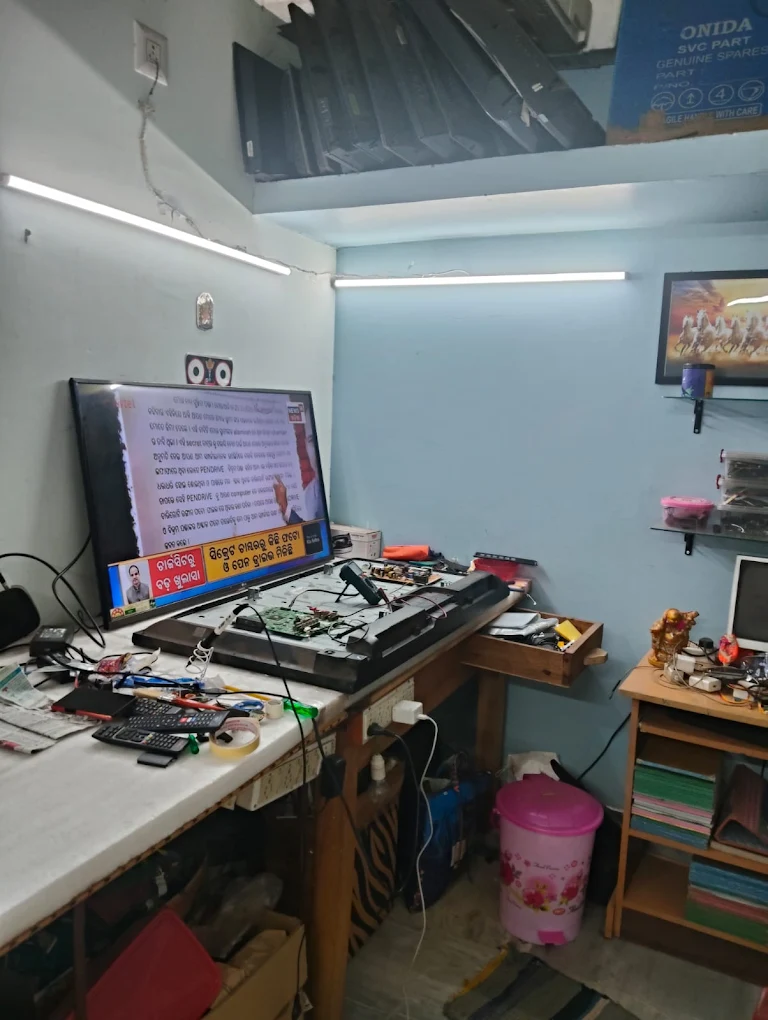 TV mechanic checking television at customer home in Bhubaneswar